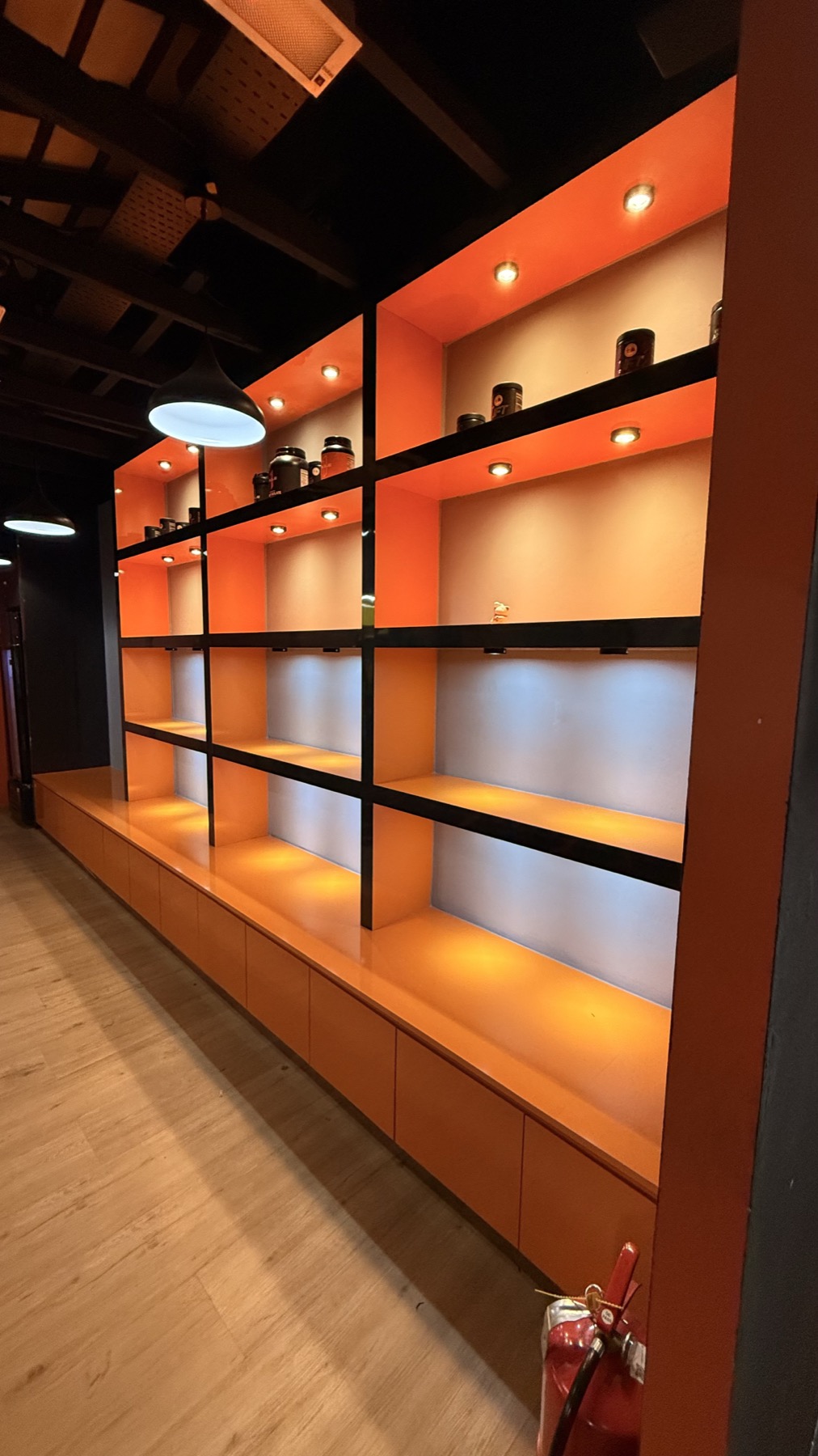 Waiting area at LEGACY+ with warm shelving and arrival lighting.
